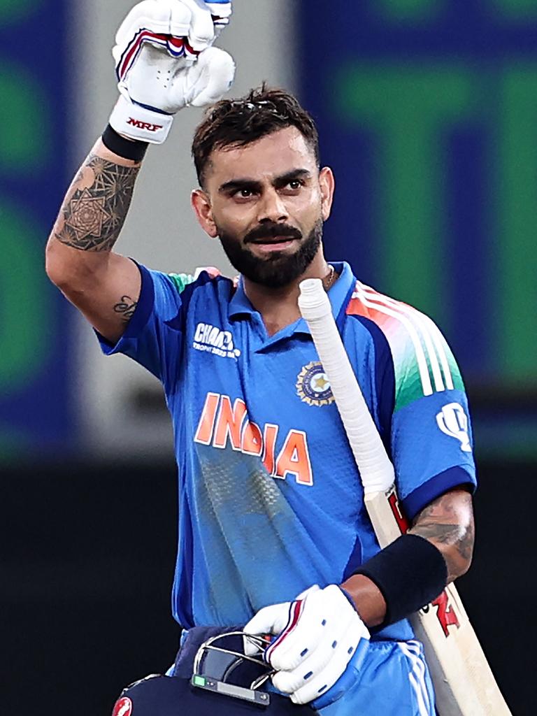 India's Virat Kohli celebrates scoring a hundred in the Champions Trophy. Photo by FADEL SENNA / AFP.