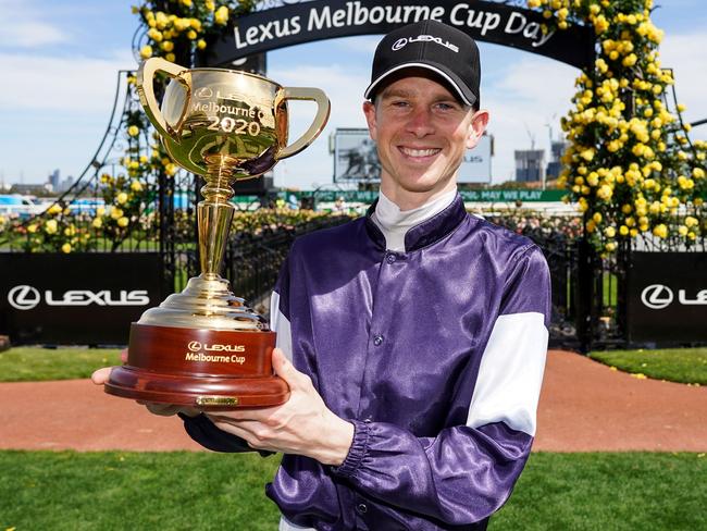 This handout photo taken and released on November 3, 2020 by Racing Photos shows Jye McNeil, who rode Twilight Payment of Ireland, celebrating with the trophy after winning the Melbourne Cup at Flemington Racecourse in Melbourne. (Photo by Scott Barbour / RACING PHOTOS / AFP) / XGTY / EDITORS NOTE ----RESTRICTED TO EDITORIAL USE MANDATORY CREDIT " AFP PHOTO /SCOTT BARBOUR / RACING PHOTOS" NO MARKETING NO ADVERTISING CAMPAIGNS - DISTRIBUTED AS A SERVICE TO CLIENTS - NO ARCHIVES