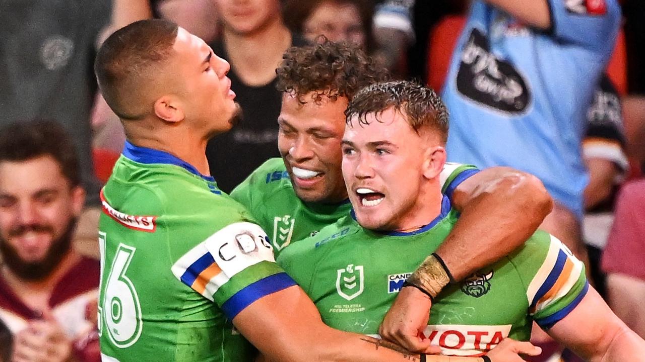 BRISBANE, AUSTRALIA – MAY 17: Hudson Young of the Raiders celebrates with Trey Mooney and Sebastian Kris of the Raiders after scoring a try during the round 11 NRL match between Canberra Raiders and Canterbury Bulldogs at Suncorp Stadium, on May 17, 2024, in Brisbane, Australia. (Photo by Bradley Kanaris/Getty Images)