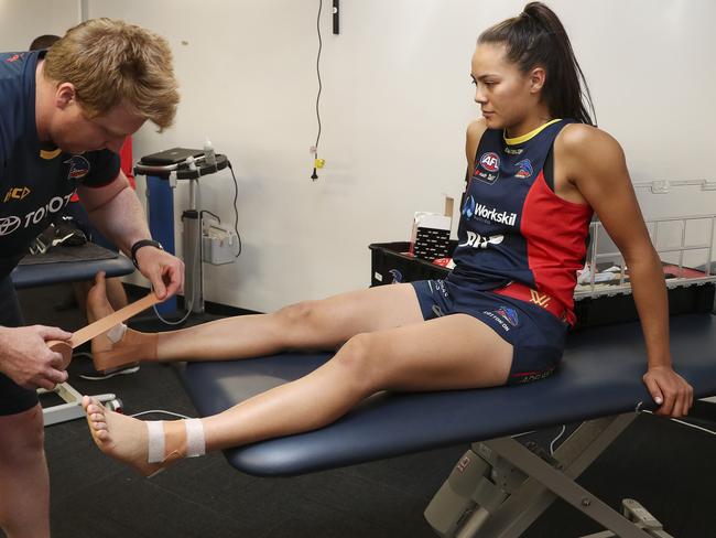 Justine Mules has her ankles strapped before a training session. Picture: SARAH REED