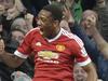 Manchester United's French striker Anthony Martial (top) celebrates scoring their third goal with Manchester United's English midfielder Ashley Young (bottom) during the English Premier League football match between Manchester United and Liverpool at Old Trafford in Manchester, north west England, on September 12, 2015. AFP PHOTO / OLI SCARFF RESTRICTED TO EDITORIAL USE. No use with unauthorized audio, video, data, fixture lists, club/league logos or 'live' services. Online in-match use limited to 75 images, no video emulation. No use in betting, games or single club/league/player publications.