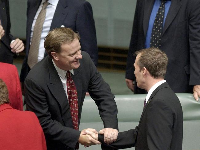 Mr Dutton is congratulated by then-Treasurer Peter Costello after giving his maiden speech in the House of Representatives in 2002.