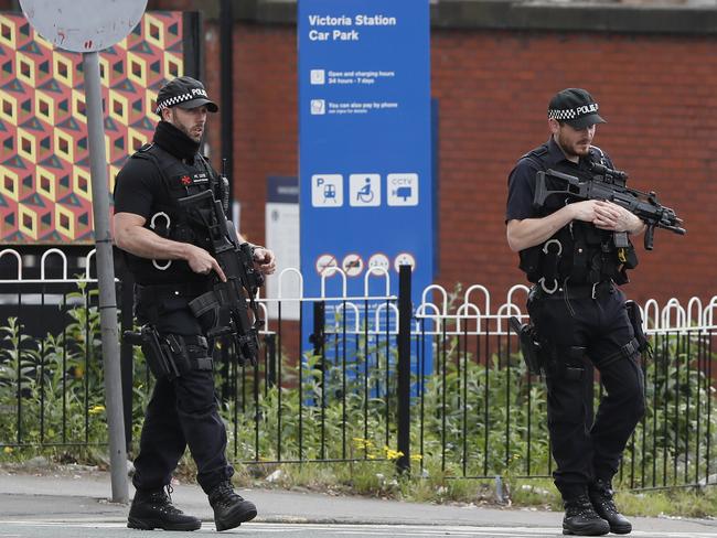 Armed police keep guard near Victoria Station in Manchester, England. Picture: AP Photo/Kirsty Wigglesworth