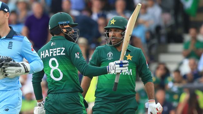 Pakistan's Mohammad Hafeez (L) celebrates with Pakistan's captain Sarfaraz Ahmed (R) after reaching his half century. Picture: AFP