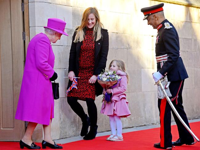 Queen Elizabeth II receives a bouquet from Evie Hayden (4) and her mother Michelle during her visit to the Honourable Society of Lincoln's Inn. Picture: Getty