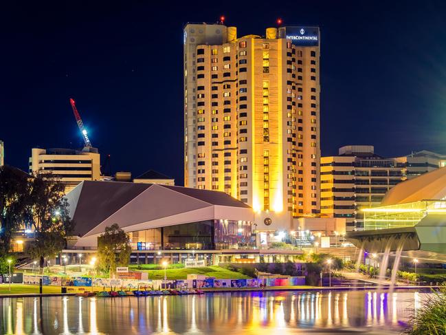 JJ6CM5 Adelaide, Australia - April 16, 2017: InterContinental Hotel in Adelaide CBD illuminated at night viewed across Torrens river