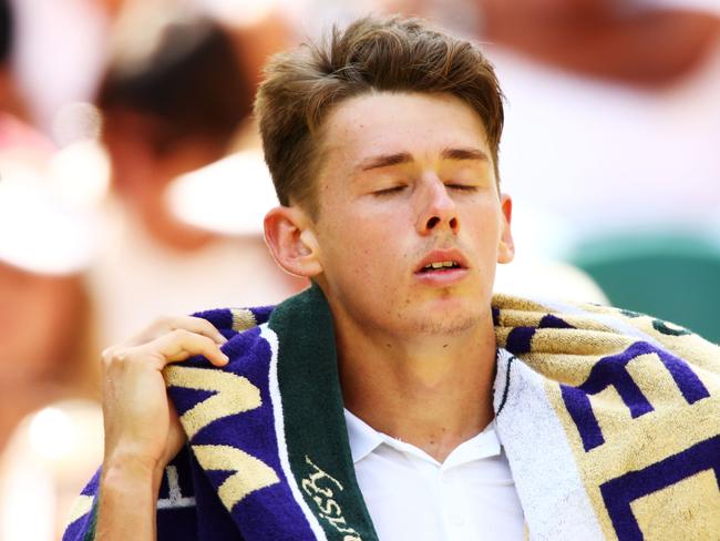 LONDON, ENGLAND - JULY 07:  Alex De Minaur of Australia towels down between games against Rafael Nadal of Spain during their Men's Singles third round match on day six of the Wimbledon Lawn Tennis Championships at All England Lawn Tennis and Croquet Club on July 7, 2018 in London, England.  (Photo by Clive Brunskill/Getty Images)