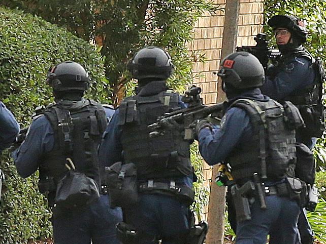 East Terrace Siege. Star Group officers rush in just after shots are heard. Picture Dylan Coker