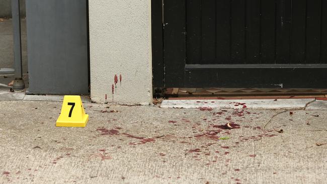 Blood was splattered on the footpath near the home in Ferris Street, Annandale. Picture: Richard Dobson