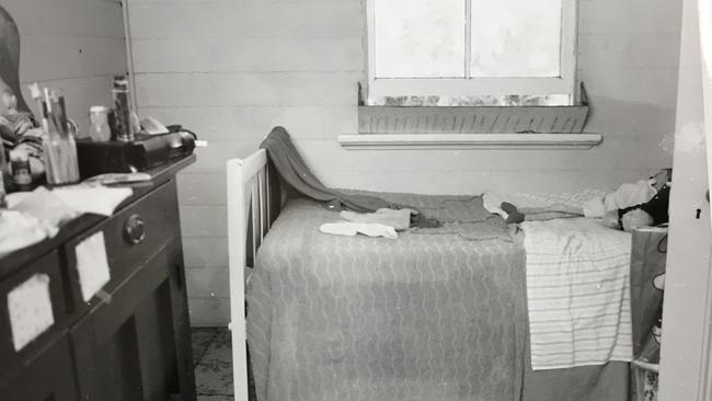 A photographs tendered to court shows one of the girl’s rooms. Two dolls rest on the bed.