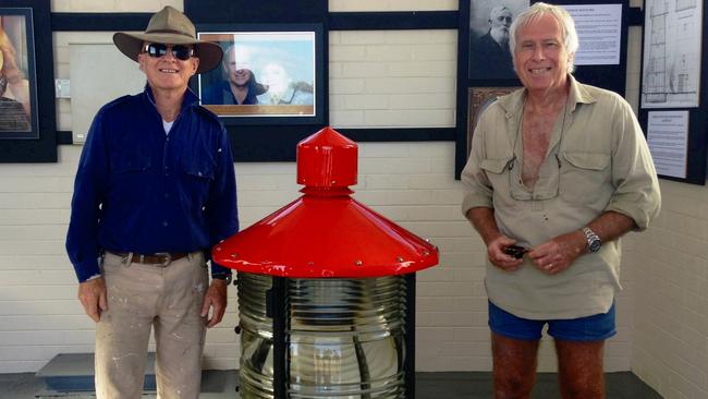 Bustard Head lighthouse volunteer Dudley Fulton and lighthouse keeper Stuart Buchanan with a restored light on display at the lighthouse complex.