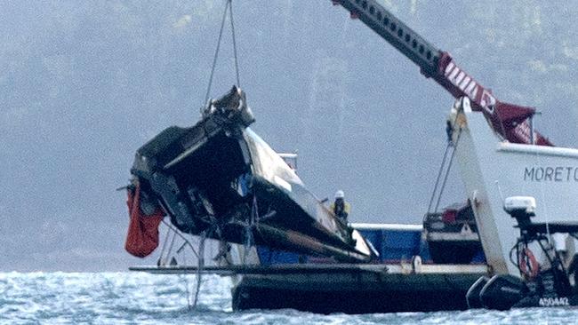 A barge lifts the tail of the MRH-90 military helicopter out of the water. Picture:Michaela Harlow