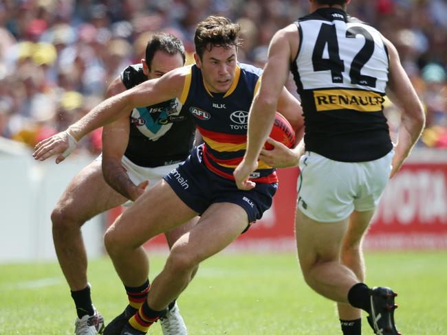 Mitch McGovern looks to step around a tackle from Tom Jonas. Picture: Ben Macmahon (AAP)
