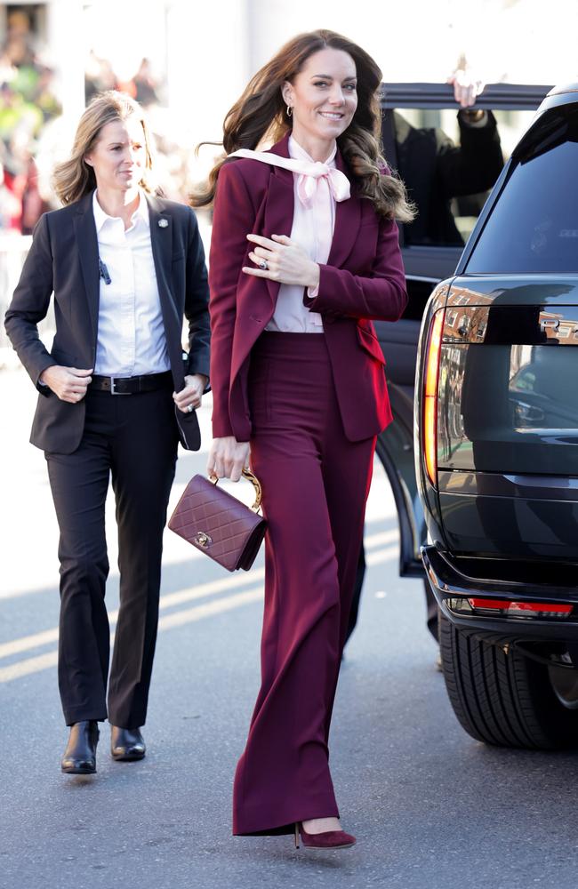 Kate was a picture of elegance in a burgundy suit, paired with a pink pussy bow blouse and matching maroon heels. Picture: Getty Images