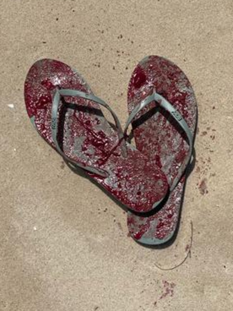 A set of blood-soaked thongs in the sand at the scene of the crash at the Broadwater.