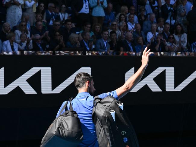 Serbia's Novak Djokovic acknowledges the applause as he exits the court after retiring from the men's singles semifinal against Germany's Alexander Zverev on day thirteen of the Australian Open tennis tournament in Melbourne on January 24, 2025. (Photo by WILLIAM WEST / AFP) / -- IMAGE RESTRICTED TO EDITORIAL USE - STRICTLY NO COMMERCIAL USE --