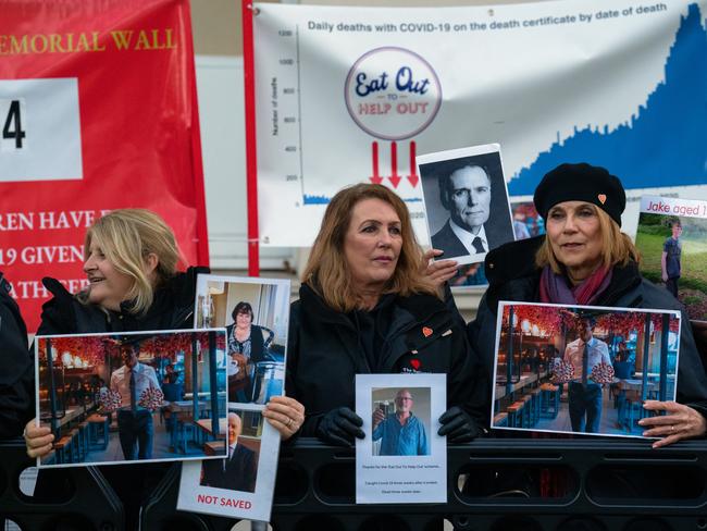 People hold posters as they protest before the arrival of Britain's Prime Minister, Rishi Sunak, at the Covid Inquiry on December 11, 2023 in London. Picture: Getty Images