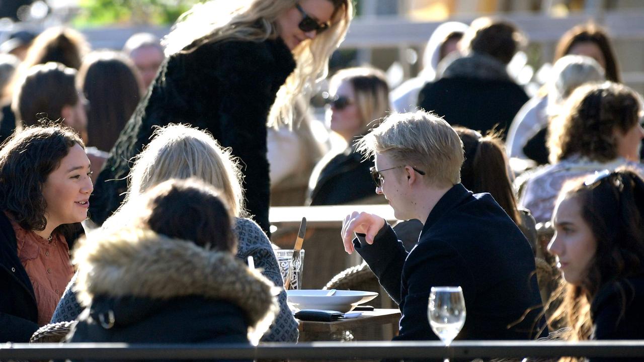 People enjoy the sun at a terrace bar in central Stockholm in Sweden. Picture: Janerik Henriksson/AFP