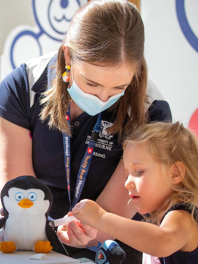 Scarlett, 4, works on Penguin with Natalie. Picture: Mark Stewart