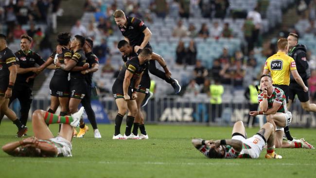 Damien Cook dejected at fulltime as the Panthers celebrate the win. Picture: Jonathan Ng