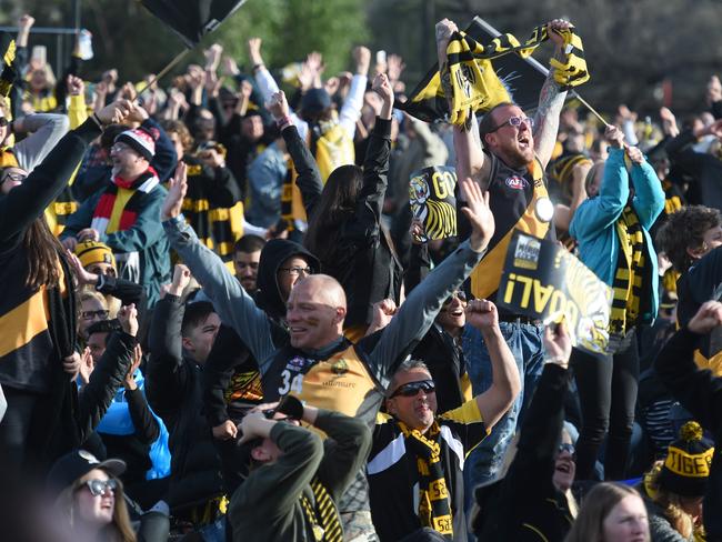 Richmond supporters go wild at Punt Road Oval after their team wins the 2017 AFL Grand Final. Picture Tony Gough