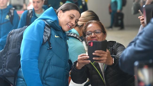 Matildas captain Sam Kerr poses for a photo with a fan as the victorious squad left their Sydney hotel to fly back to Brisbane on Tuesday. Picture: Jeremy Piper