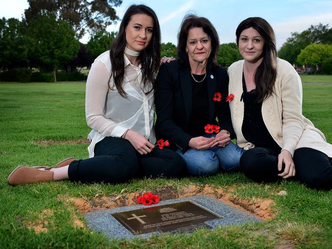 Vicki Crannaford (centre) with her daughters Meegan & Brooke at the veteran memorial grave of their grandfather and uncle, at Enfield Memorial Park. The body of Vicki's brother was brought back to Australia this year, after he died during battle in 1966 picture: Bianca De Marchi