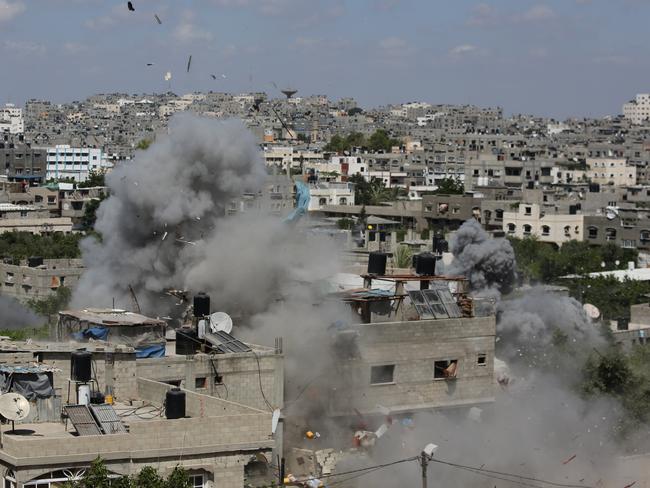 Smoke and debris rises as an Israeli missile strike hits a building in Jabalya refugee camp in the northern Gaza strip yesterday. (AP Photo/Hatem Moussa)