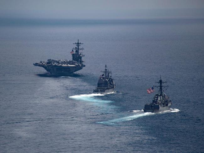 USS Carl Vinson (left) leading the Arleigh Burke-class guided-missile destroyer USS Michael Murphy (centre) and the Ticonderoga-class guided-missile cruiser USS Lake Champlain in the Indian Ocean on April 14, 2017. Picture: Danny Kelley/US Navy/AFP