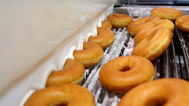 The doughnuts go through the glaze tower. Picture: Carmela Roche