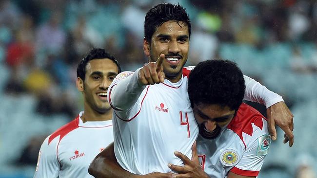 Sayed Dhiya (C) of Bahrain celebrates his goal against Qatar with teammate Abdulwahab Al Malood during their Group C football match at the AFC Asian Cup in Sydney on January 19, 2015. AFP PHOTO / Saeed KHAN --IMAGE RESTRICTED TO EDITORIAL USE - STRICTLY NO COMMERCIAL USE