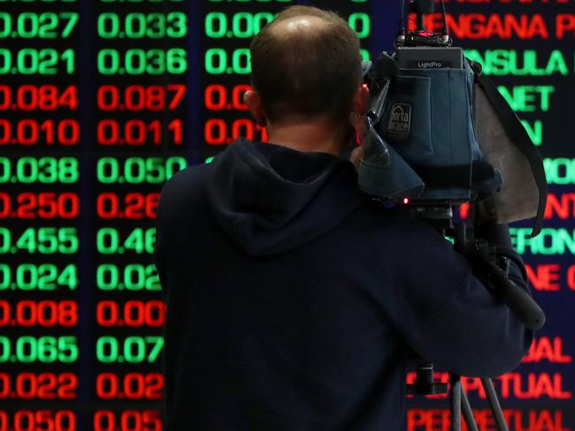 SYDNEY, AUSTRALIA - AUGUST 06: A TV camera person records electronic boards displaying stock information at the Australian Securities Exchange, operated by ASX Ltd. on August 06, 2024 in Sydney, Australia. The markets are closely attuned to the RBA's next rates decision, with inflation persisting even as rates have been elevated for an extended time after the end of the COVID-19 pandemic. (Photo by Lisa Maree Williams/Getty Images)