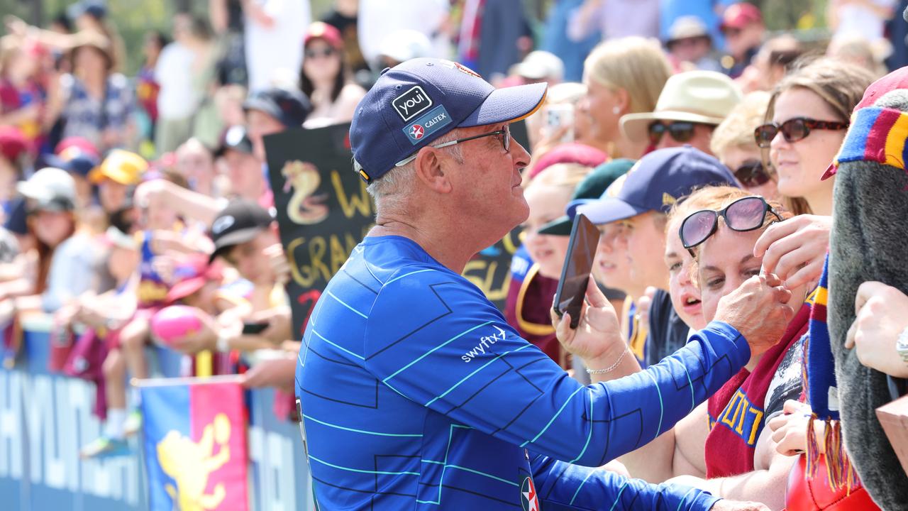 Lions coach Chris Fagan signs autographs for fans. Picture: Lachie Millard