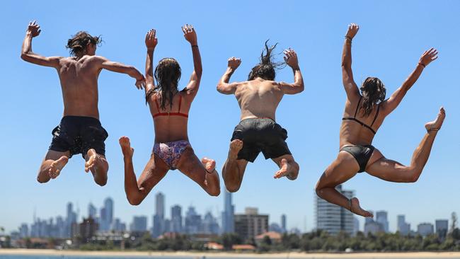 Matthew, Alex, Hayden, and Macey jump into the water at St Kilda Beach. Picture: Alex Coppel