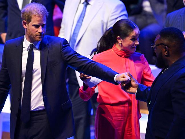 Prince Harry salutes Zimbabwe’s rugby player Tendai Mtawarira at the annual One Young World Summit at Bridgewater Hall in Manchester. Picture: AFP