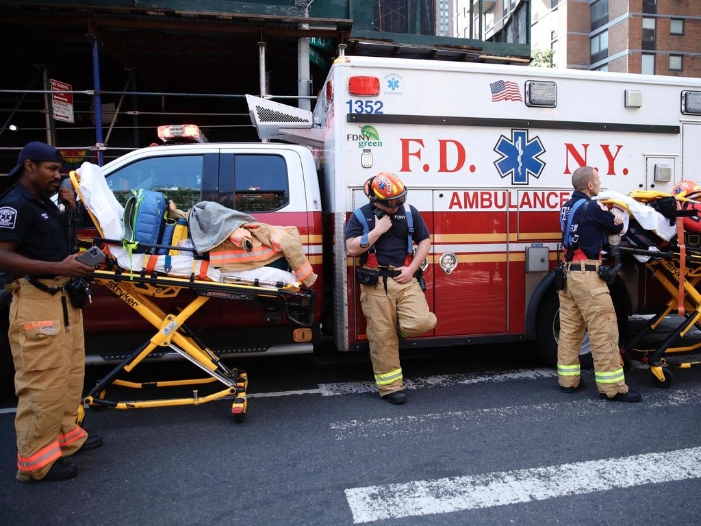 Firefighters are ready with stretchers at the site of a construction crane fire and collapse in New York. Picture: AFP