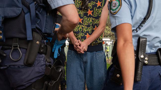 A man was seen being detained by police at the Field Day Music festival in Sydney. Picture: NCA NewsWire / Flavio Brancaleone