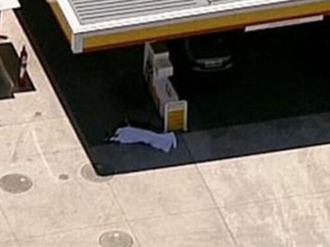 The body of Darren Wallace lies near a bowser / Picture: Channel 9