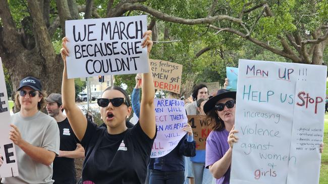 Stephanie Clarke leads the chanting as more than 100 people march in the No More Violence Rally in Toowoomba's Queens Park, organised by volunteer group What Were You Wearing to advocate for more funding to stop domestic and family violence.