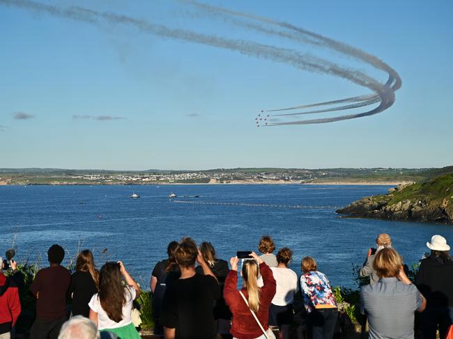 People watch the Red Arrows fly over Carbis Bay during the G7 summit. Picture: Getty Images