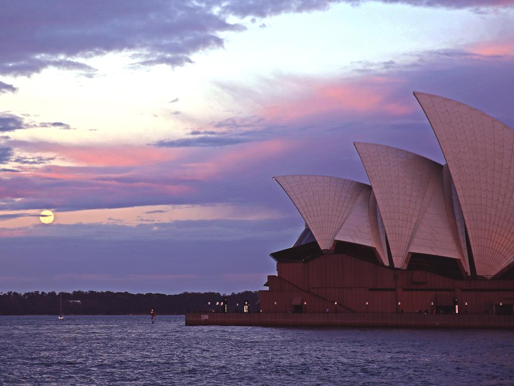 The supermoon peering across Sydney Harbour to the Opera House. Picture: Nicholas Eagar