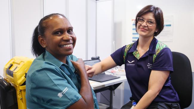 Torres Strait Islander liaison officer for the Infection Prevention Service Valerie Nancarrow receives aCovid vaccination from Cairns Hospital clinical nurse Camilla Clem. Picture: Brendan Radke