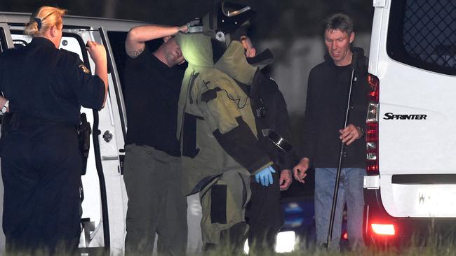A bomb squad member suited up before walking toward police station after the shooting. Pic: Mike Keating