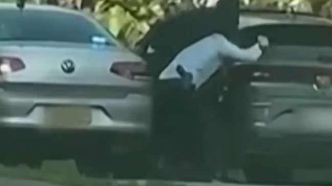 Screen shots from Channel Seven News of police tussling with one of the two men who have been accused of a conspiracy to execute a high profile Sydney identity. Picture: Channel 7