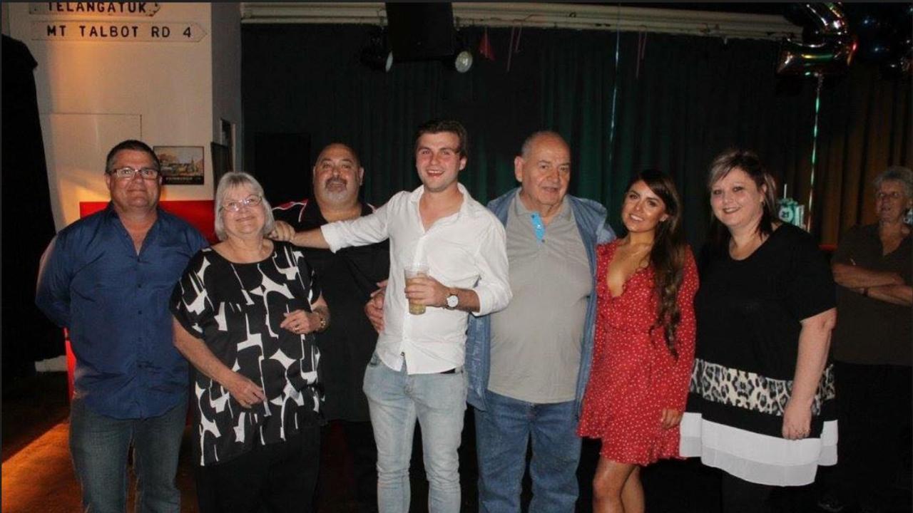 Kayla Wright (red dress) with her family, far left, Paul, her dad, her grandmother, uncle Trevor, brother Kyle, grandfather, and mum Stacey. Picture: Supplied by family