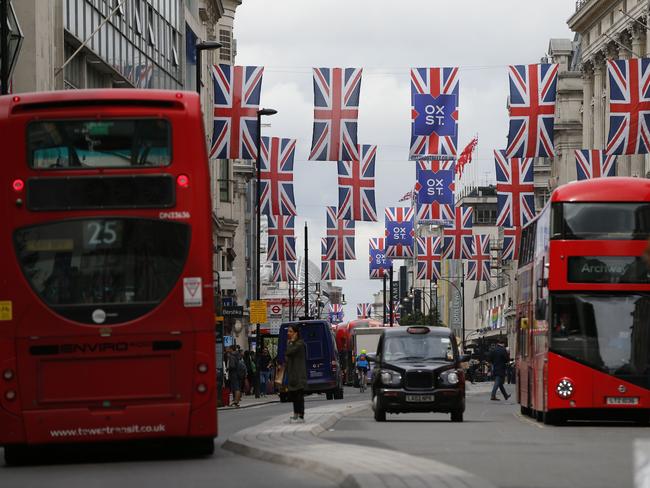 Union flags are attached between buildings along Oxford street in central london on June 27, 2016. Shares in banks, airlines and property companies plunged on the London stock exchange Monday as investors singled out the three sectors as being the most vulnerable to Britain's decision to leave the EU. / AFP PHOTO / ODD ANDERSEN