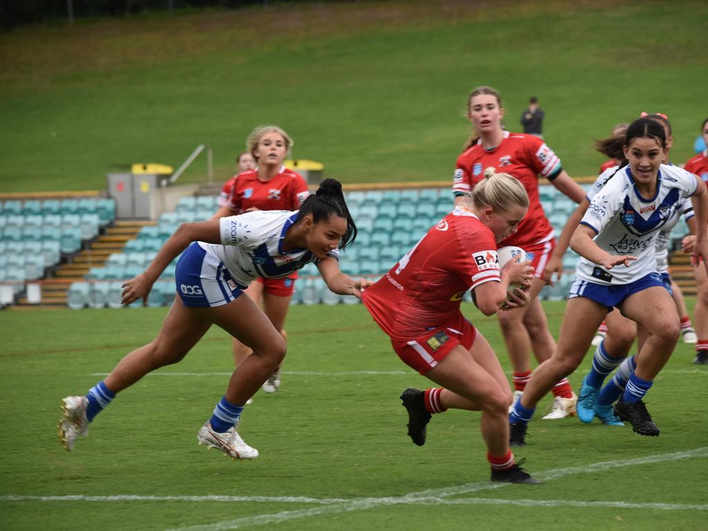 Mia-Rose Walsh tries to evade the defence of Ebony Raftstrand-Smith. Picture: Sean Teuma/NewsLocal