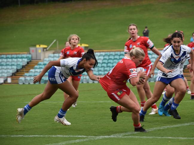 Mia-Rose Walsh tries to evade the defence of Ebony Raftstrand-Smith. Picture: Sean Teuma/NewsLocal