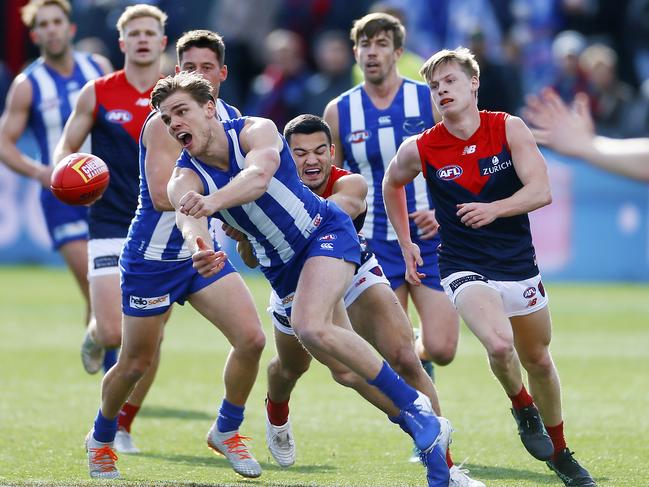 AFL crowd colour - North Melbourne v Melbourne, at Blundstone Arena, Bellerive.  (L-R) North Melbourne's Jy Simpkin looks to handball.Picture: MATT THOMPSON