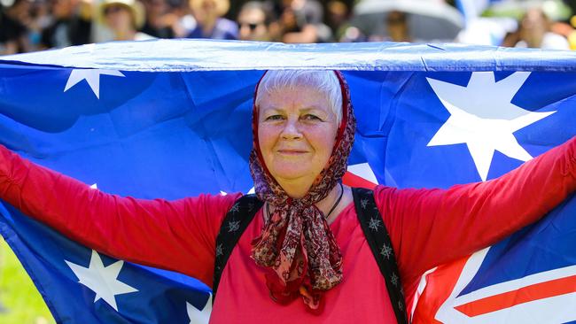 A woman marching with the Australian flag in Sydney. Picture: NCA NewsWire /Gaye Gerard